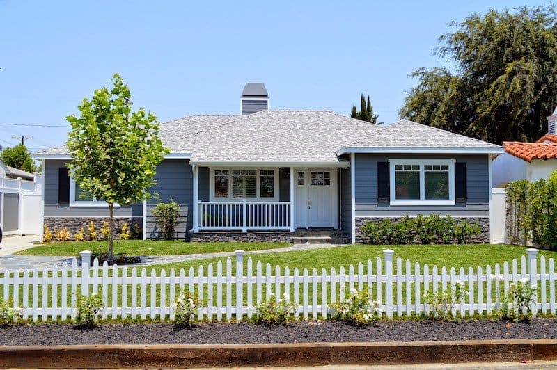 Modern wooden fence surrounding a landscaped yard